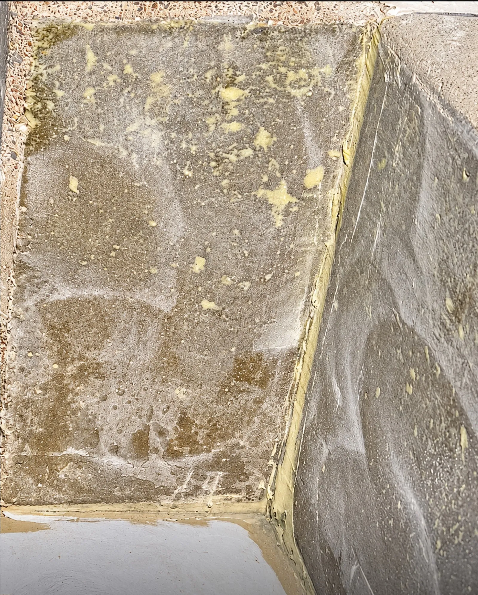 Close view of a prepared concrete bund wall with an epoxy sealer applied.